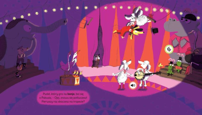 Książka dźwiękowa „Pakuś i orkiestra cyrkowa” – arena cyrkowa, pies Pakuś skacze z trapezu i prawie spada, łapie go pudel i wciąga na drugi trapez; pudel gra na banjo, wszystkie zwierzęta martwią się o Pakusia